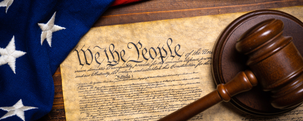 Photo montage of the U.S. Constitution, a gavel and the American flag