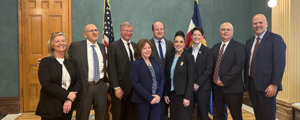 Colorado Supreme Court Justices pose with Gov. Polis and Lt. Gov Primavera after Justice Blanco's swearing in  