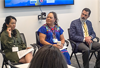 Thumbnail of panel of 3 seated speakers. A lady in a green dress is speaking and the other guest panelists are looking at her.