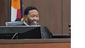 Judge Marques Ivey, an African American man, seated in his robe smiling on the bench of a courtroom